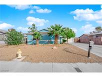 Charming single-story home showcasing xeriscaping, and vibrant palm trees at 6552 Roy Rogers Dr, Las Vegas, NV 89108