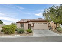 Charming single-story home features desert landscaping and a two-car garage at 7908 House Sparrow St, North Las Vegas, NV 89084