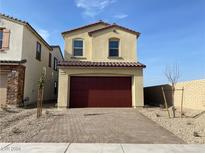 Two-story house with a red garage door and paved driveway at 657 N Water St, Henderson, NV 89015