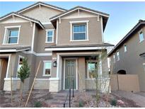 Two-story home with neutral exterior and landscaping at 568 Celebratory Pl, Henderson, NV 89011