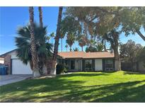 Charming single-story home with well-maintained lawn and mature trees providing ample shade at 3909 Woodhill Ave, Las Vegas, NV 89121