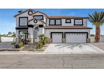 Two-story stucco home with a two car garage, palm trees and stone accents at 6315 N El Capitan Way, Las Vegas, NV 89149