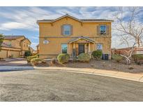 Two-story home with desert landscaping, shuttered windows, and a welcoming covered porch at 1065 Admiral Emblem St, Henderson, NV 89015