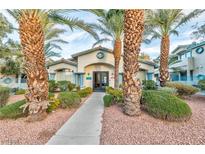 Community clubhouse with tropical landscaping and a welcoming entrance at 4960 Harrison Dr # 214, Las Vegas, NV 89120