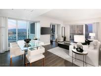 Bright, open-concept living room with floor-to-ceiling windows showcasing panoramic city views at 2700 Las Vegas Blvd # 2303, Las Vegas, NV 89109