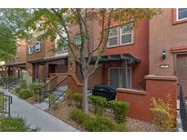 Charming townhome exterior with a cozy front patio and well-maintained landscaping at 4650 Ranch House Rd # 62, North Las Vegas, NV 89031
