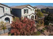 Charming two-story home featuring desert landscaping, decorative shutters, and an inviting arched entryway at 10631 Sariah Skye Ave, Las Vegas, NV 89166