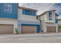 Modern three-story townhome with attached garage and neutral color palette at 2667 Kindswood St, Henderson, NV 89044