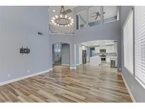 Open living room with high ceilings and hardwood floors at 8774 Libertyvale Dr, Las Vegas, NV 89123