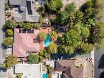 Stunning aerial view of property with a private pool, lush landscaping, and solar panels at 3841 Hildebrand Ln, Las Vegas, NV 89121