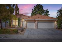 Charming home with a tile roof, manicured front yard, and a two-car garage in a residential neighborhood at 3134 Alfa Romero Ave, North Las Vegas, NV 89031