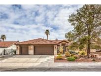 Charming single-story home featuring a terracotta roof and a three-car garage at 8021 Bronzewood Ave, Las Vegas, NV 89149