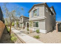 Charming gray two-story townhomes with blue shutters and desert landscaping at 1323 Cerulean Ave, Henderson, NV 89002