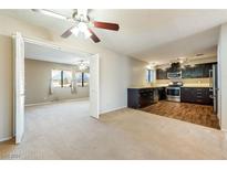 Open kitchen features stainless steel appliances and dark wood cabinets at 2360 Greyhound St, Pahrump, NV 89060