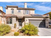 Charming two-story stucco home with a tile roof, solar panels, and a well-manicured front yard at 3256 Umbria Gardens Ave, Las Vegas, NV 89141