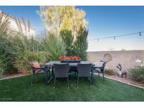 Private backyard with patio furniture and artificial turf at 3368 Epson St, Las Vegas, NV 89129