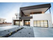 Contemporary two-story home with contrasting black and white exterior, two-car garage and desert landscaping at 3690 S Spring Mountain Blvd, Pahrump, NV 89048