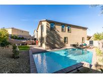 Inviting backyard featuring a private pool, patio, and well-maintained landscaping for outdoor enjoyment at 2947 Caxton Grove Dr, Henderson, NV 89052