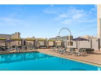Rooftop pool featuring comfortable lounge chairs and views of the Las Vegas skyline, including the High Roller observation wheel at 211 E Flamingo Rd # 610, Las Vegas, NV 89169