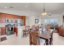 Bright kitchen features stainless steel appliances and an island at 3532 Labrusca Vines Ct, North Las Vegas, NV 89081