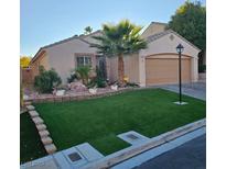 Charming single-story home featuring an immaculate front yard with artifical turf and a mature palm tree at 11261 Playa Caribe Ave, Las Vegas, NV 89138