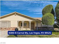 Single-story house with a landscaped lawn and attached carport at 4386 El Carnal Way, Las Vegas, NV 89121