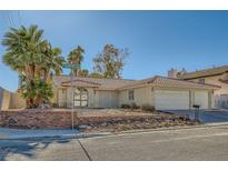 Single-story house with a three-car garage and desert landscaping at 3189 Lipton Ct, Las Vegas, NV 89121