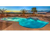 Inviting pool and spa with mountain views at sunset at 1052 Hollyhock Dr, Henderson, NV 89011