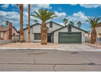 Single-story house with a two-car garage and desert landscaping at 7230 Mountain Moss Dr, Las Vegas, NV 89147