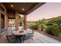 Relaxing patio with fire pit and seating area, overlooking a landscaped backyard at 1004 Crest View Dr, Mesquite, NV 89027