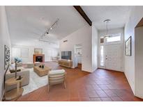 Bright living room featuring a fireplace, neutral furnishings, and terra cotta tile flooring at 5255 Dickens Dr # 0, Las Vegas, NV 89119