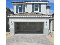 Two story home featuring neutral paint, large windows with shutters, and a spacious two car garage at 7110 Parkallen Ave, Las Vegas, NV 89113