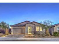 Charming single-story home featuring a two-car garage, stone accents, and a well-manicured front yard at 617 Sylvan St, Henderson, NV 89002
