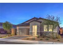 Single-story home with a two-car garage and landscaped front yard at 617 Sylvan St, Henderson, NV 89002