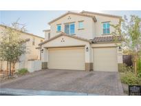 Two-story home features a spacious two-car garage, neutral color palette, and well-maintained landscaping at 35 Flora Sagio Ave, Henderson, NV 89011