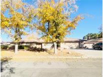 Single-story home with mature trees and a spacious front yard at 3690 S Rosecrest Cir, Las Vegas, NV 89121