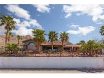 Single-story home with Spanish tile roof, landscaped yard, and mountain views at 440 Probst, Las Vegas, NV 89110