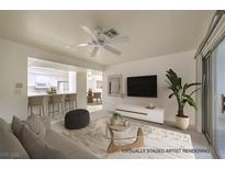 Bright living room features a ceiling fan, and a view into the kitchen at 2725 S Nellis Blvd # 1096, Las Vegas, NV 89121