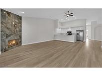 Bright living room with fireplace and hardwood floors at 5404 Harmony Green Dr # 201, Las Vegas, NV 89149