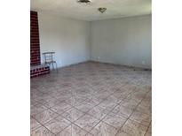 Spacious living room features tiled flooring and a brick fireplace, offering a comfortable and stylish space at 1604 Luning Dr, Las Vegas, NV 89106