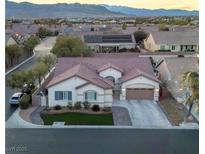 Charming single-story home boasting a well-manicured lawn and attached two car garage against a scenic desert landscape at 7321 Gentle Valley St, Las Vegas, NV 89149