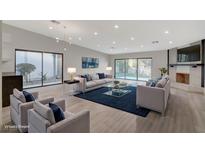 Bright living room with fireplace and sliding glass doors leading to backyard at 3012 Plaza De Rosa, Las Vegas, NV 89102