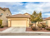 Single-story house with a two-car garage and well-maintained landscaping at 1204 Oceanwood Ave, North Las Vegas, NV 89086