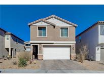 Two-story house with a white garage door and landscaping at 4132 Spring Storm Ave, North Las Vegas, NV 89081