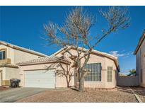 Single-story house with a white garage door and landscaped front yard at 3456 Beca Faith Dr, North Las Vegas, NV 89032