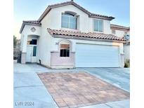 Charming two-story home with stucco exterior, tile roof and a spacious two car garage at 3667 Spring Willow Ct, Las Vegas, NV 89147