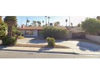 Ranch style home with a large front yard and driveway at 1589 Silver Mesa Way, Las Vegas, NV 89169