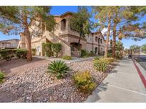 Two-story condo building with landscaping and gated entrance at 5751 E Hacienda Ave # 107, Las Vegas, NV 89122