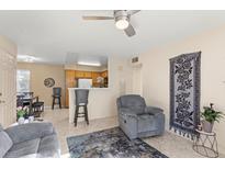 Inviting living room with ceiling fan, tile flooring, and convenient kitchen access at 3425 E Russell Rd # 240, Las Vegas, NV 89120