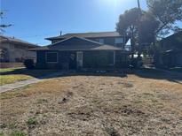 Two-story building with a dark blue exterior and a grassy yard at 1521 Elizabeth Ave # 4, Las Vegas, NV 89119